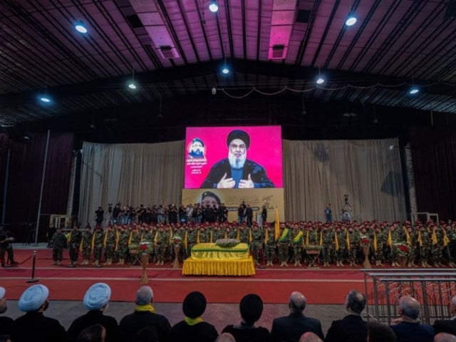 a televised speech by hezbollah chief hassan nasrallah is transmitted on large screens as fighters and mourners attend the funeral ceremony of slain top commander fuad shukr in beirut s southern suburbs on august 1 2024 khaled desouki afp photo abs cbn